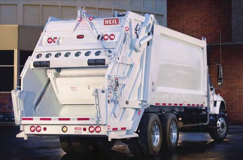 Rear view of a white garbage truck.